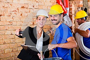 Builder and architect working on construction site