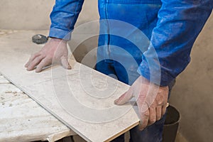 Builder bricklayer installs ceramic tiles. Apartment renovation. Construction concept