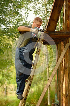 Builder or carpenter working and builds a roof