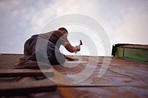 Builder or carpenter working on the roof