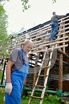 Builder or carpenter working on the roof