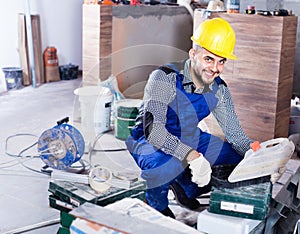 Builder is choosing tools in suitcase for work