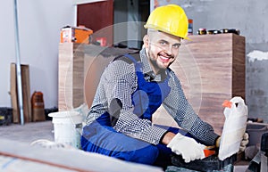 Builder is choosing tools in suitcase for work