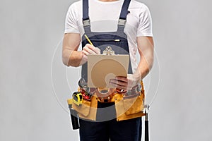 Builder with clipboard, pencil and working tools