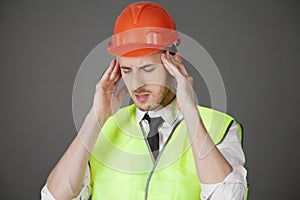 The Builder closes his eyes in pain