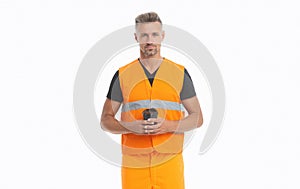 Builder with coffee. Guy in safety vest having coffee break. Constructor holding paper coffee cup