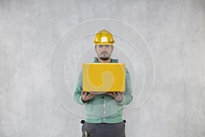 Builder with a computer in his hands