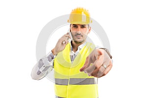 Builder or constructor pointing finger at camera