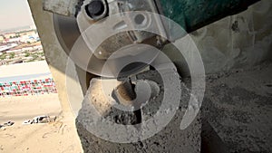 Builder of cutting heavy duty stone, angle grinder.