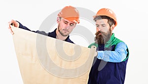 Builder, engineer, architect work at site. Men in helmets