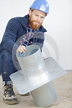 builder examining metal chimney flue