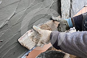 builder faces the basement of a house with a wild stone. Flat fo