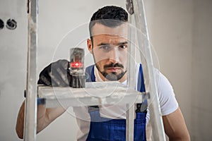 The builder uses an electronic ruler, close-up