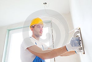 Builder with grinding tool indoors