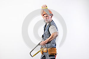 A builder with hacksaws in a helmet mocks. On a light background