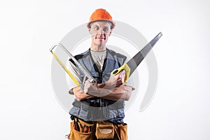 A builder with hacksaws in a helmet mocks. On a light background photo