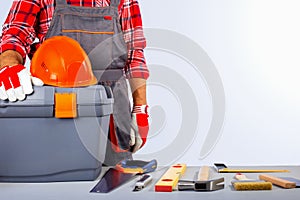 Builder handyman with construction tools.