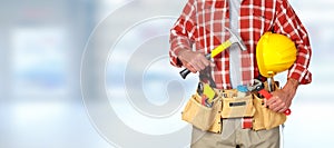 Builder handyman with construction tools.