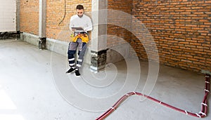 Builder handyman with construction tools. House renovation background
