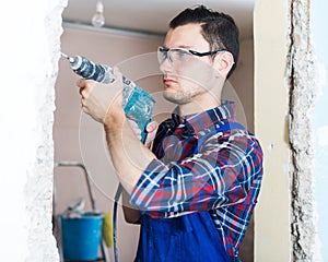 Builder handyman working with electric drill