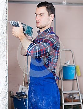 Builder handyman working with electric drill
