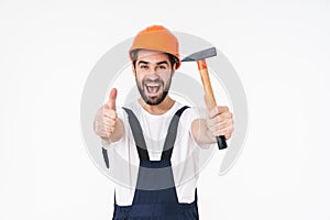 Builder in helmet holding hammer showing thumbs up