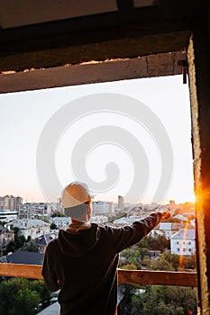 Hard hat builder inside building under construction
