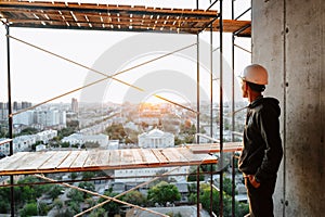 Hard hat builder inside building under construction
