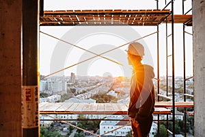 Hard hat builder inside building under construction