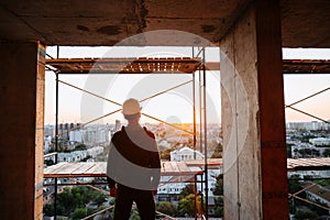Hard hat builder inside building under construction