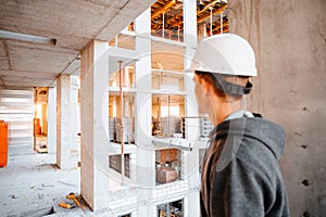 Hard hat builder inside building under construction