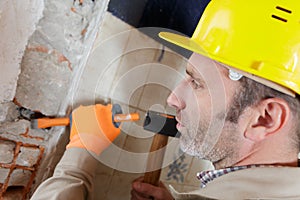 builder hitting wall with hammer