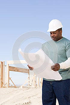 A builder holding a blueprint