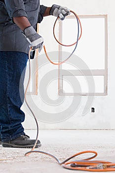 A builder holding a cable