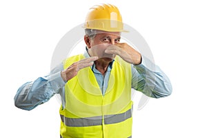 Builder holding nose with hand