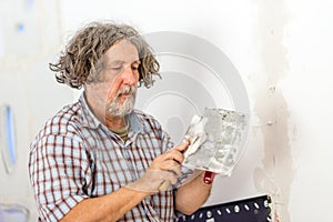 Builder or homeowner repairing a wall