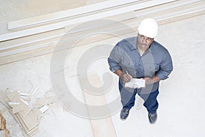 A builder inspecting a house