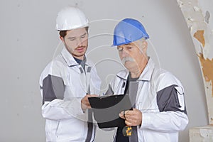 Builder and inspector looking at unfinished property