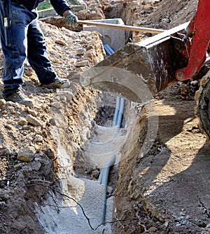 Builder installing pipes