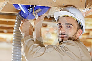 builder installing pipes in site