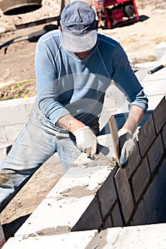 Builder laying bricks