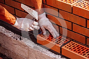 Builder laying bricks on construction site