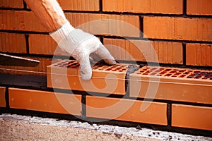 Builder laying bricks on construction site