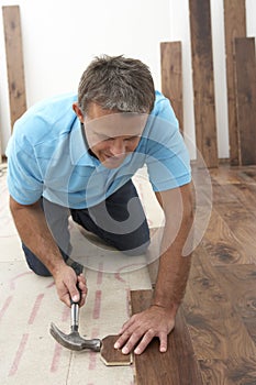 Builder Laying Wooden Flooring