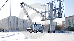 Builder on a Lift Platform at a construction site. Men at work. construction worker assembling scaffold on building site