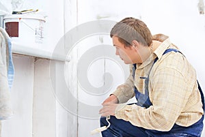 Builder looking at the paint wall