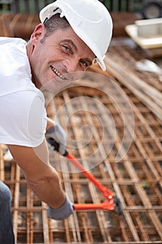 Builder making net steel bars at construction site