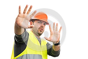 Builder man having scared expression making stay away gesture