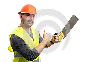 Builder man holding saw making thumb-up like gesture