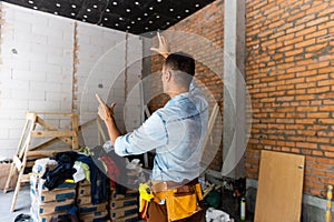 Builder man using media interface. Mixed media.